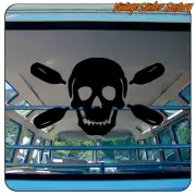 Black skull sticker with four paddles applied inside a vehicle
