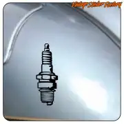 Adhesive spark plug applied to a grey surface