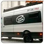 Pegatina «beer inside» aplicada en el lateral de una furgoneta camper blanca
