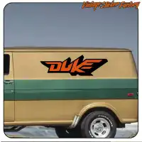 Two-tone orange and black Duke logo applied to the side of a vintage van