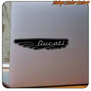 Black sticker with winged Ducati logo applied to a smooth surface