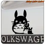 Totoro design with two small figures applied to the rear of a vehicle