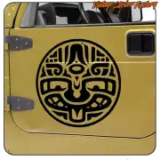 Black circular design with stylised face applied to the door of a yellow vehicle