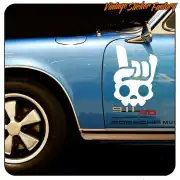 White skull sticker applied to the door of a classic blue Porsche