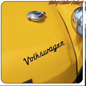Black Volkswagen text applied to the yellow bonnet of a classic car