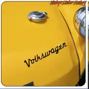 Black Volkswagen text applied to the yellow bonnet of a classic car