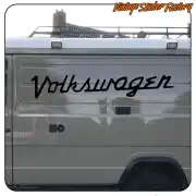 Black Volkswagen text applied to the rear of a grey van