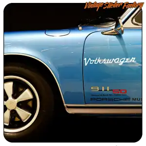 White Volkswagen text applied to the door of a blue sports car