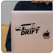 DRIFT sticker with sports car silhouette applied to a laptop