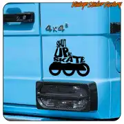 SHUT UP & SKATE adhesive applied to the side of a blue vehicle