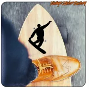 Black snowboarder silhouette applied to a board beside a shoe