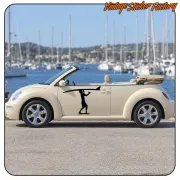 Black surfer silhouette with board applied to the door of a light-coloured convertible