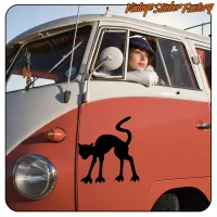 Black silhouette of a cat with claws on the side of a vintage van, alternative view