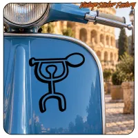 Autocollant avec motif tribal noir placé sur l’avant bleu d’une moto classique