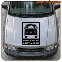 Front view of a van with the FREECAMPING IS NOT A CRIME sticker on the bonnet