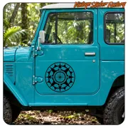 Black compass rose applied to the door of a blue vehicle