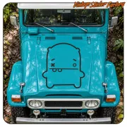 Black-outlined monster applied to the bonnet of a blue vehicle