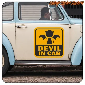 “DEVIL IN CAR” sticker applied to the door of a classic car