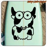 Cartoon cow sticker applied to a light green board