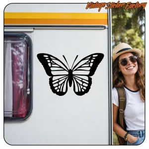 Black butterfly sticker applied to the white side of a motorhome