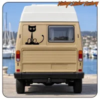 Rear view of a beige van with the black cat sticker applied to the door