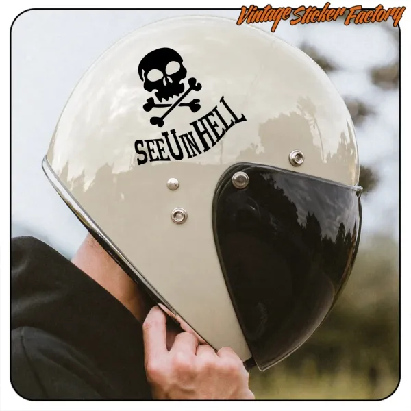 Motorcycle helmet with skull sticker and SEE YOU IN HELL text