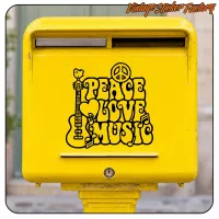 PEACE LOVE MUSIC sticker applied to a yellow letterbox