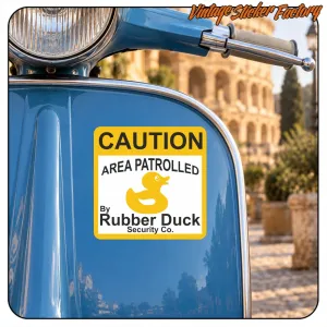 Caution sticker with rubber duck applied to the side of a blue scooter