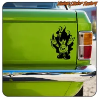 View of the black horned character adhesive applied beside the rear light of a green van