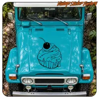 Front view of a turquoise vehicle with the cupcake design applied to the hood