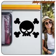 Black skull with crossed bones applied to the side of a caravan