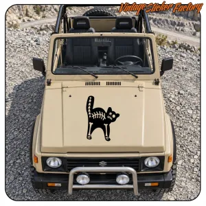 Black cat with white skeleton applied to the bonnet of a beige off-road vehicle