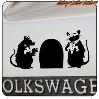 Sticker of two dressed rats beside an arched entrance, applied to a vehicle