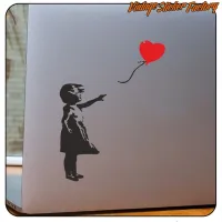 Detalle del vinilo de niña y globo rojo aplicado en la tapa de un portátil