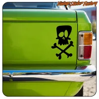 Black skull sticker with crossed bones on a green van, rear view
