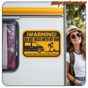 Multicolour warning sticker applied to the side of a motorhome