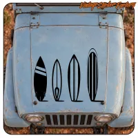 Front view of a vintage vehicle with four black surfboard silhouettes on the bonnet