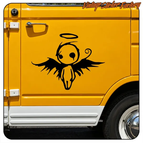 Close-up of the black fallen angel placed on the yellow door of a vintage vehicle