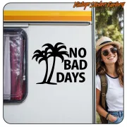 Black “NO BAD DAYS” sticker applied to a caravan beside a woman