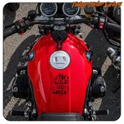 «STAY WILD GO ROCK» sticker placed on the red fuel tank of a motorcycle