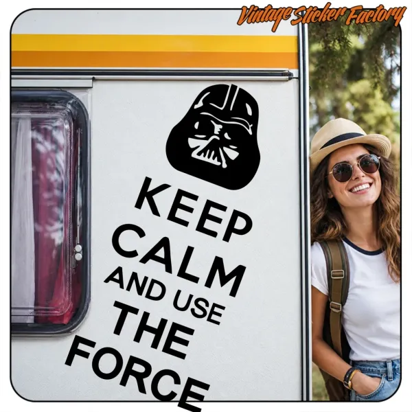 Application of the adhesive with «KEEP CALM AND USE THE FORCE» text on a caravan, next to a person