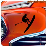 Black paddleboarding silhouette on the shiny bodywork of a classic car