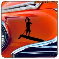 Sticker of a person with dreadlocks on a SUP board applied to an orange classic vehicle