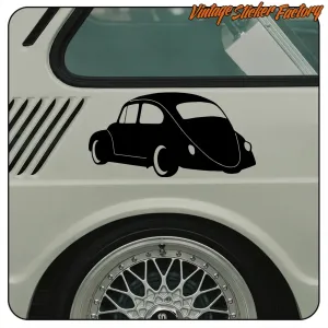 Black silhouette of a Volkswagen Beetle applied next to the wheel of a classic vehicle