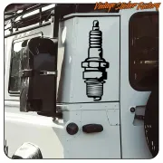 Adhesive spark plug applied to the side of a vehicle