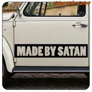 “MADE BY SATAN” text applied to the door of a classic white vehicle