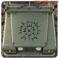Black compass rose placed on the front of a green vehicle