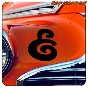 Black spiral design applied to the orange bodywork of a car
