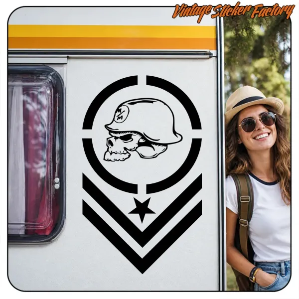 Skull design with helmet, star and chevrons applied to a caravan, beside a person