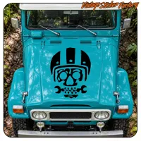 Vista frontal de un vehículo azul con el adhesivo negro de calavera con casco